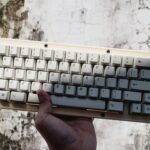 Hand holding up a keyboard